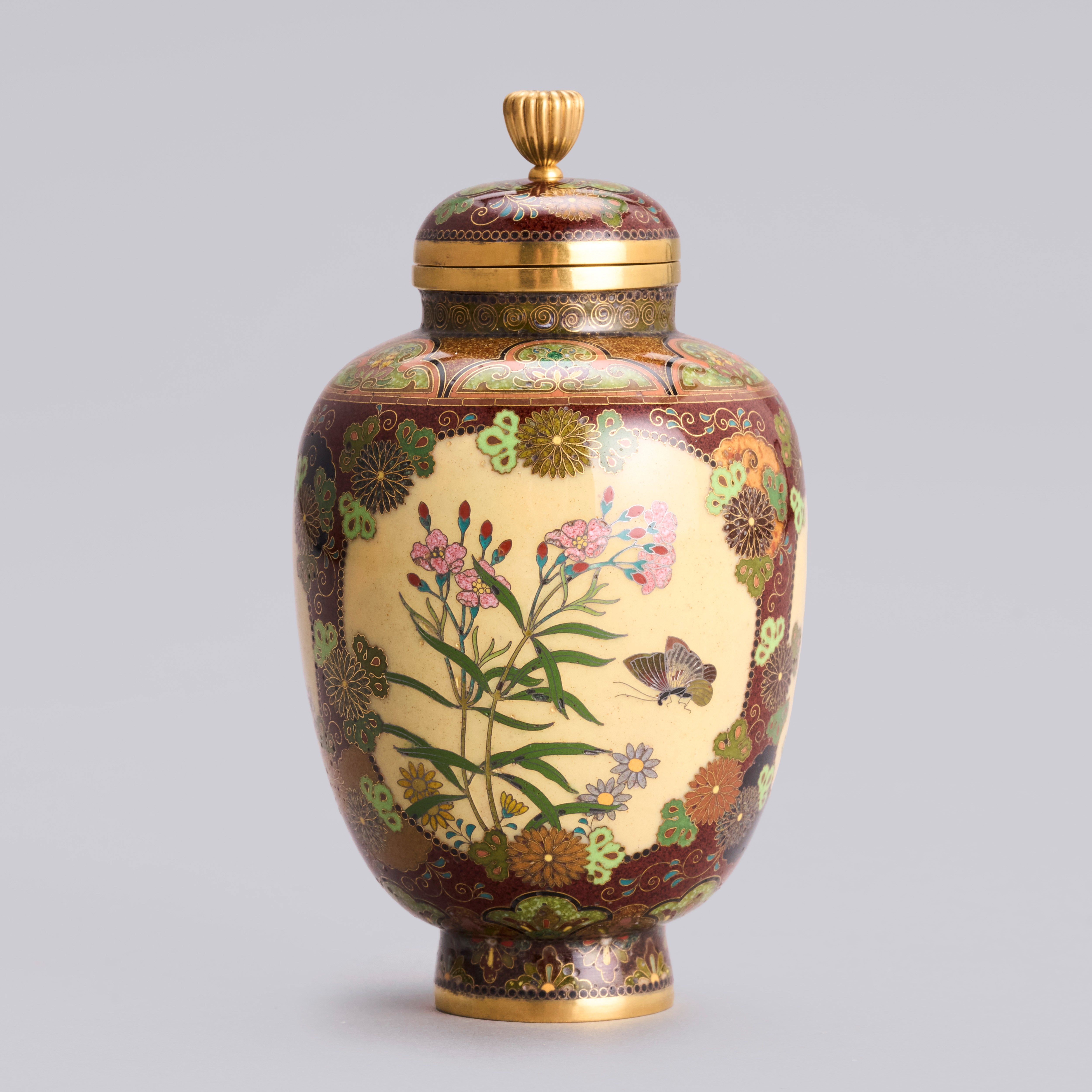 A cloisonné enamel jar worked in gold wires with butterflies and chrysanthemums, Meiji period 1868-1912.