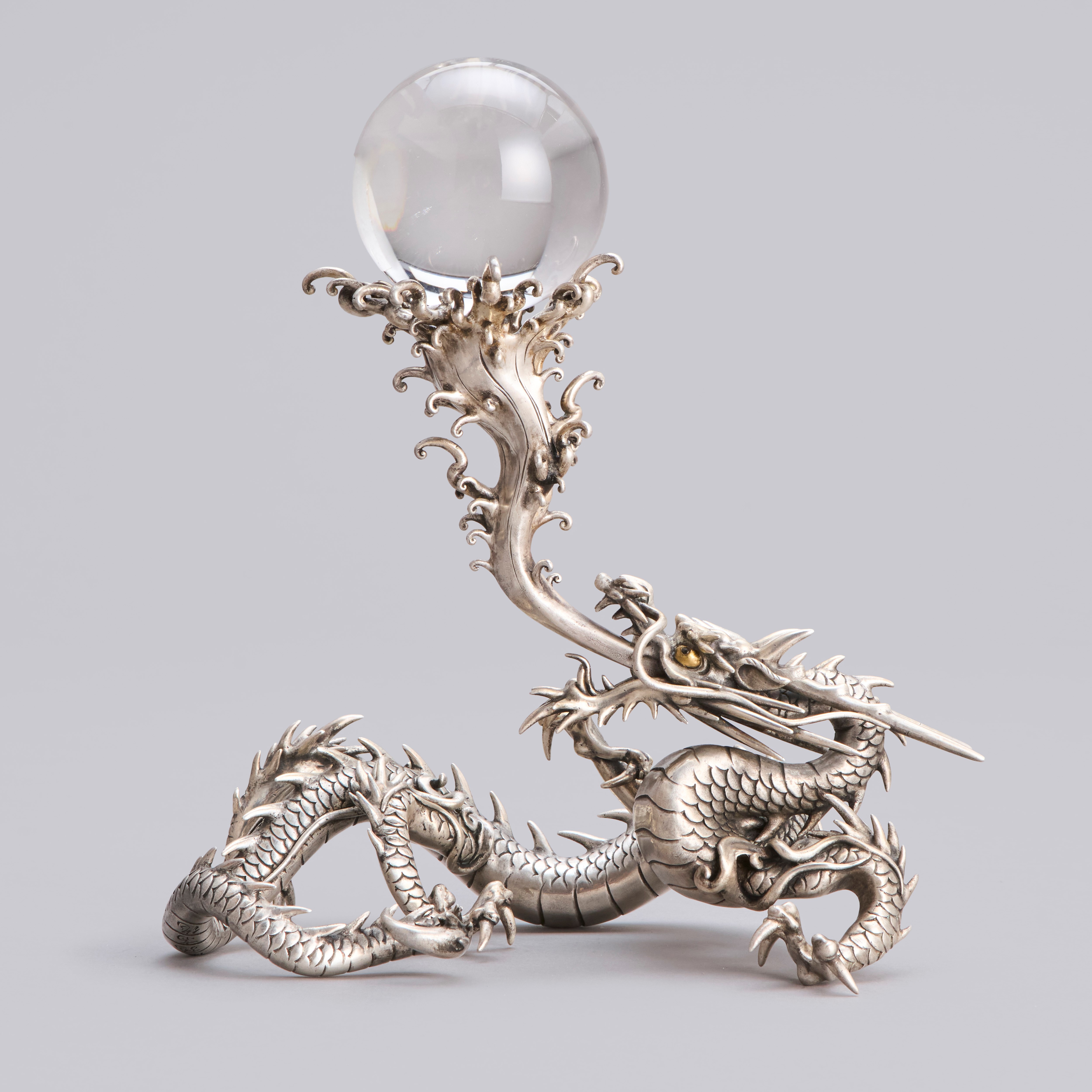 A silvered bronze writhing dragon with a swirling water spout holding the sacred jewel, Meiji period 1868-1912.