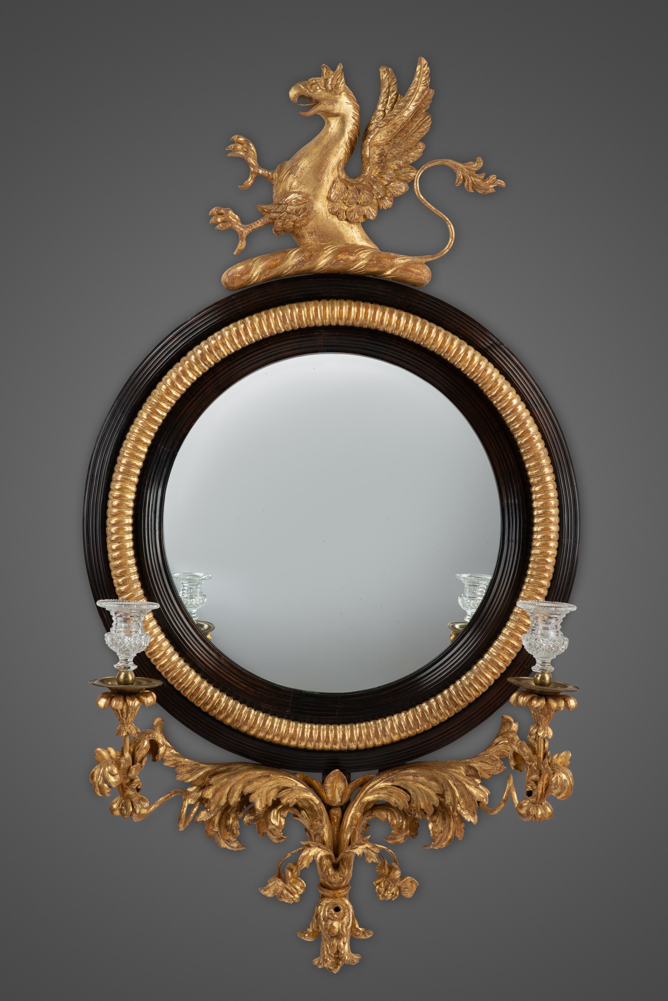 Regency Carved Giltwood and Ebony Convex Mirror with Griffin Crest